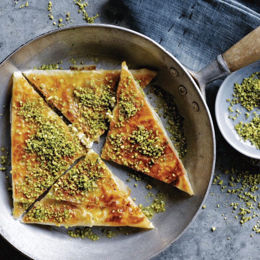 Katmer (Pistachio Pancake): This unique dessert hails from Gaziantep and features a thin, crispy pancake filled with chopped pistachios and drizzled with syrup. 